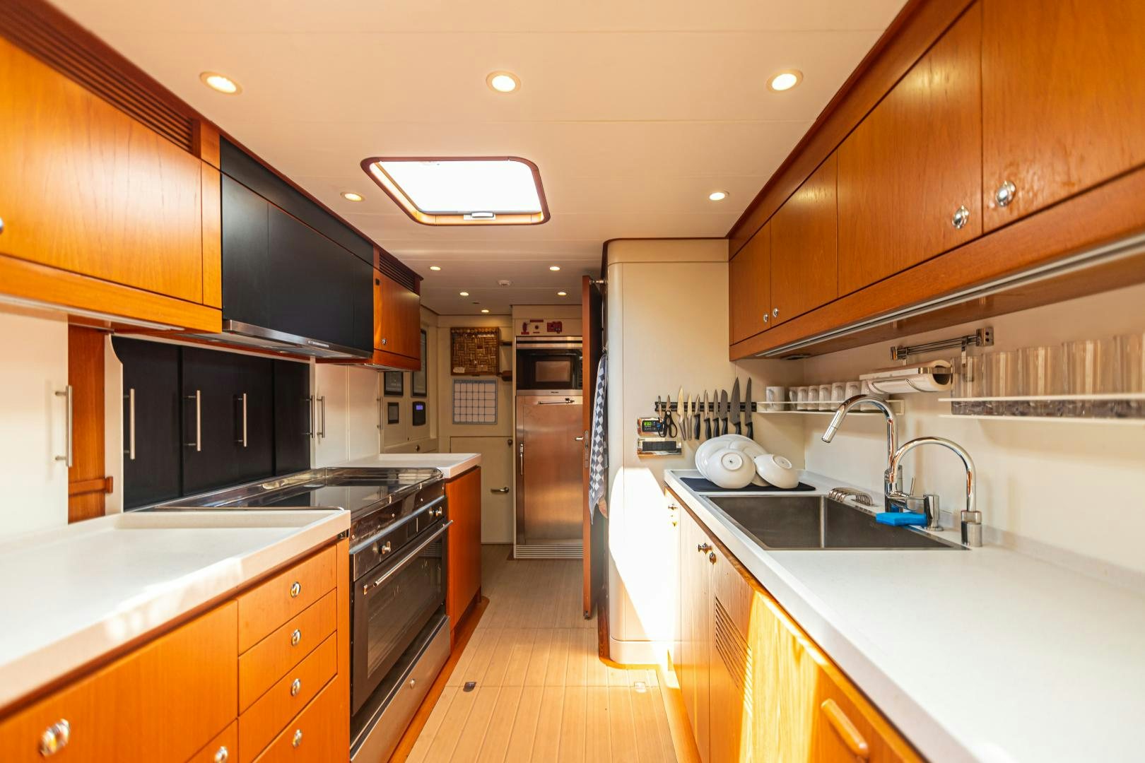 a kitchen with wooden cabinets aboard VIRAGO Yacht for Sale