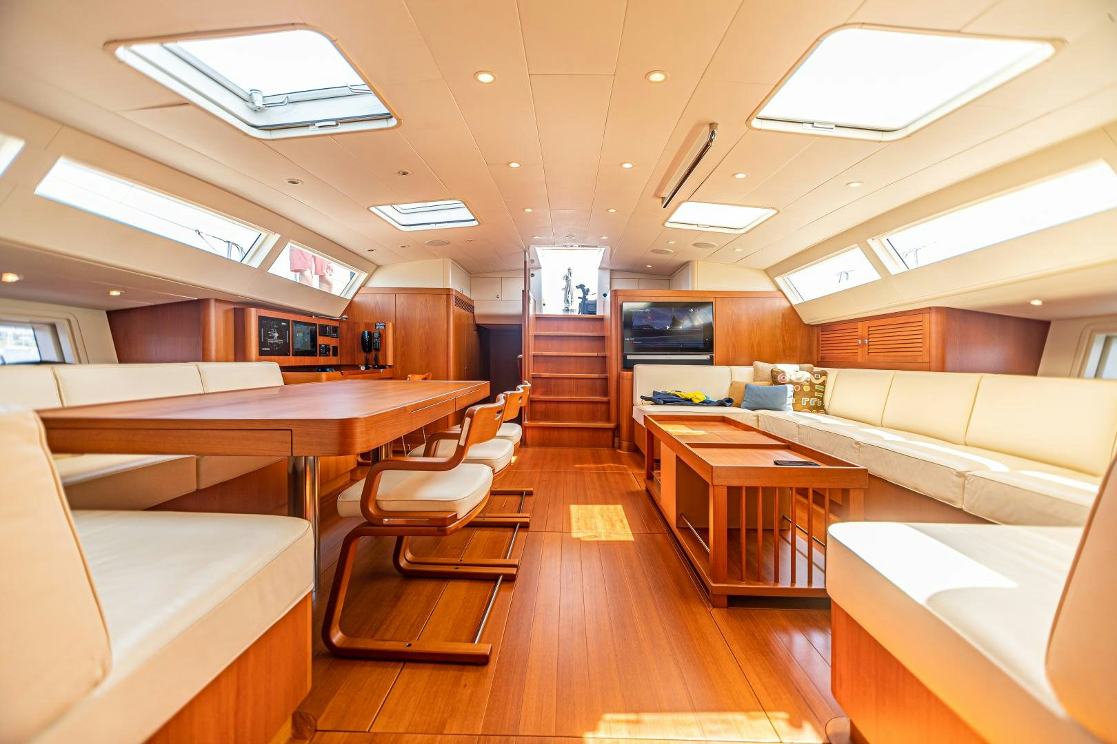 a room with a wood floor and a couch and a television aboard VIRAGO Yacht for Sale