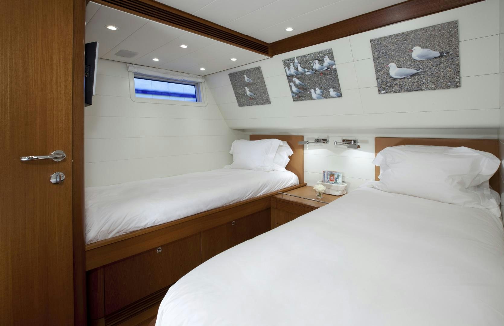 a room with two beds aboard VIRAGO Yacht for Sale