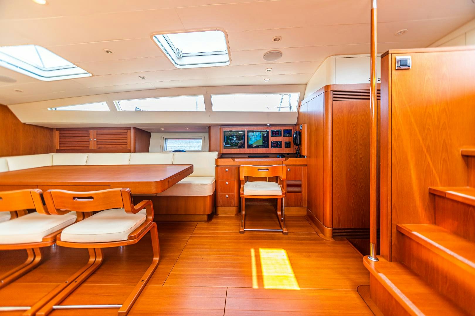 a room with desks and chairs aboard VIRAGO Yacht for Sale