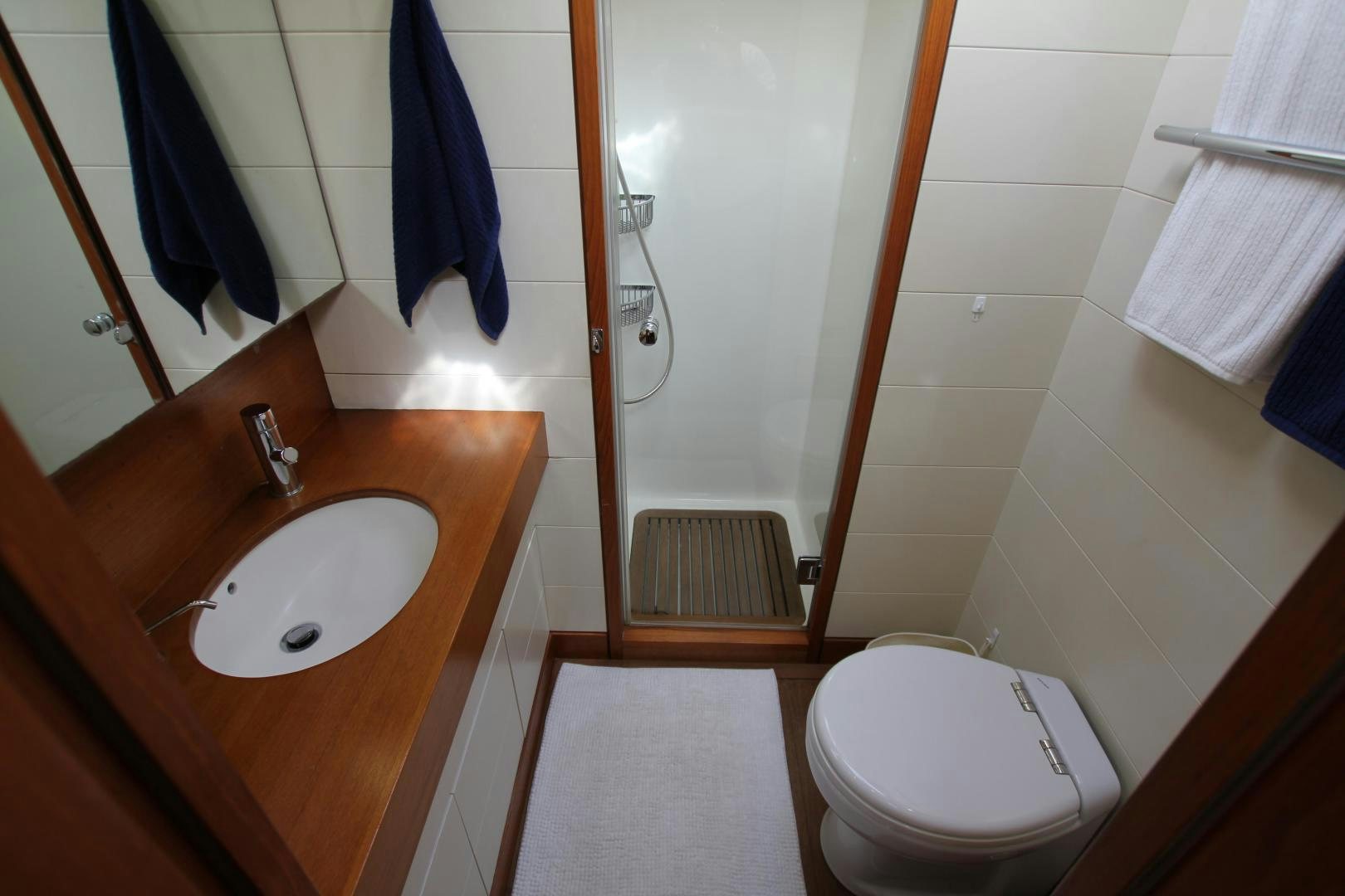 a bathroom with a sink toilet and towels aboard VIRAGO Yacht for Sale