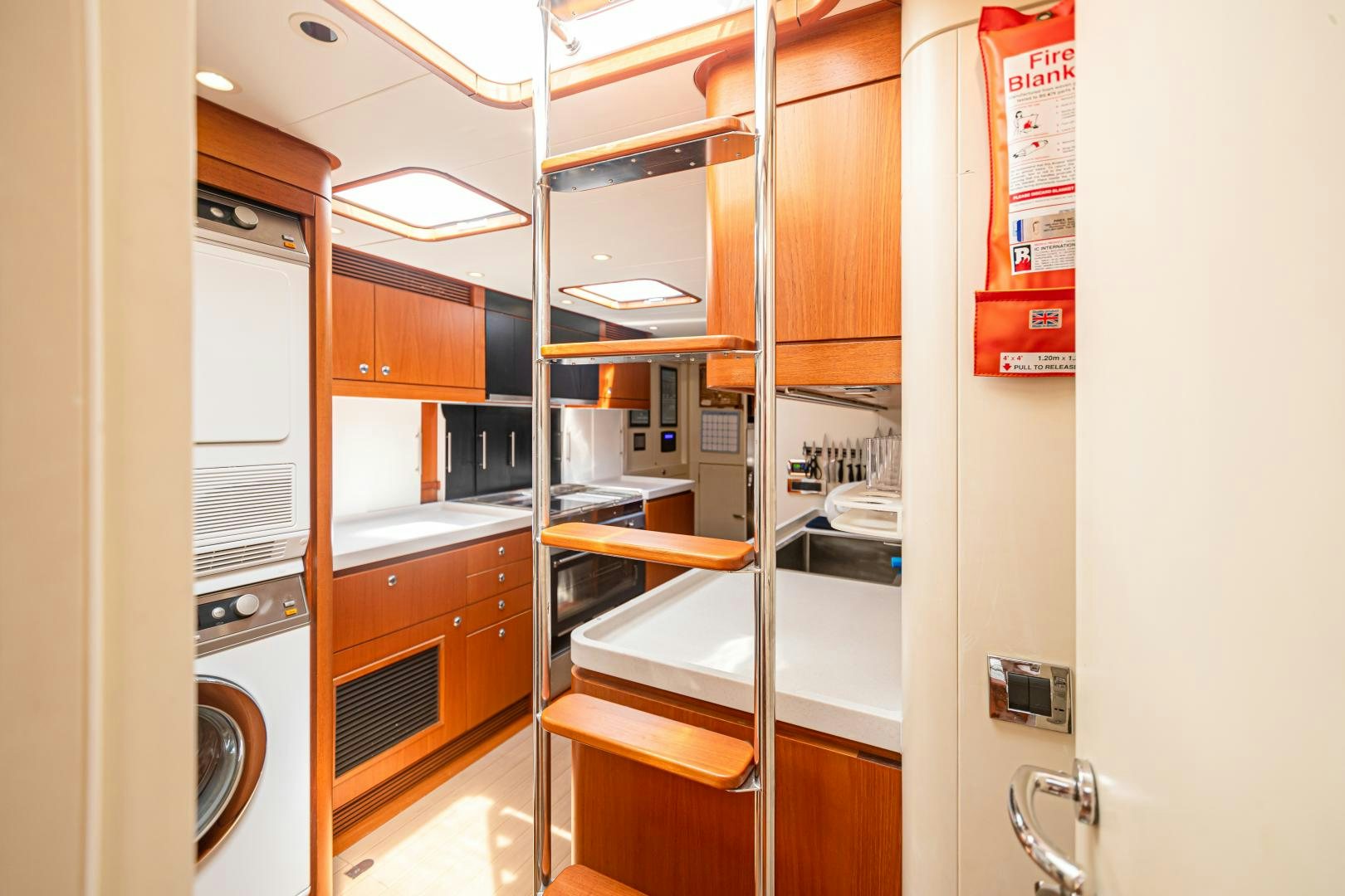 a kitchen with a large refrigerator aboard VIRAGO Yacht for Sale