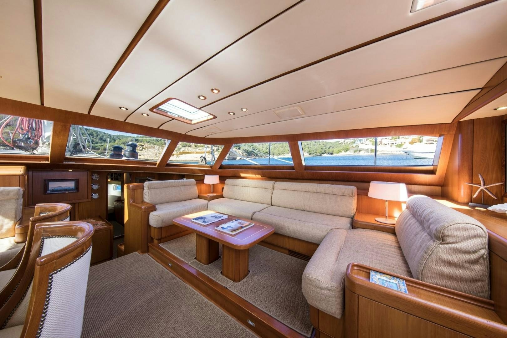 a living room with a couch and a table aboard MEDUSA Yacht for Sale