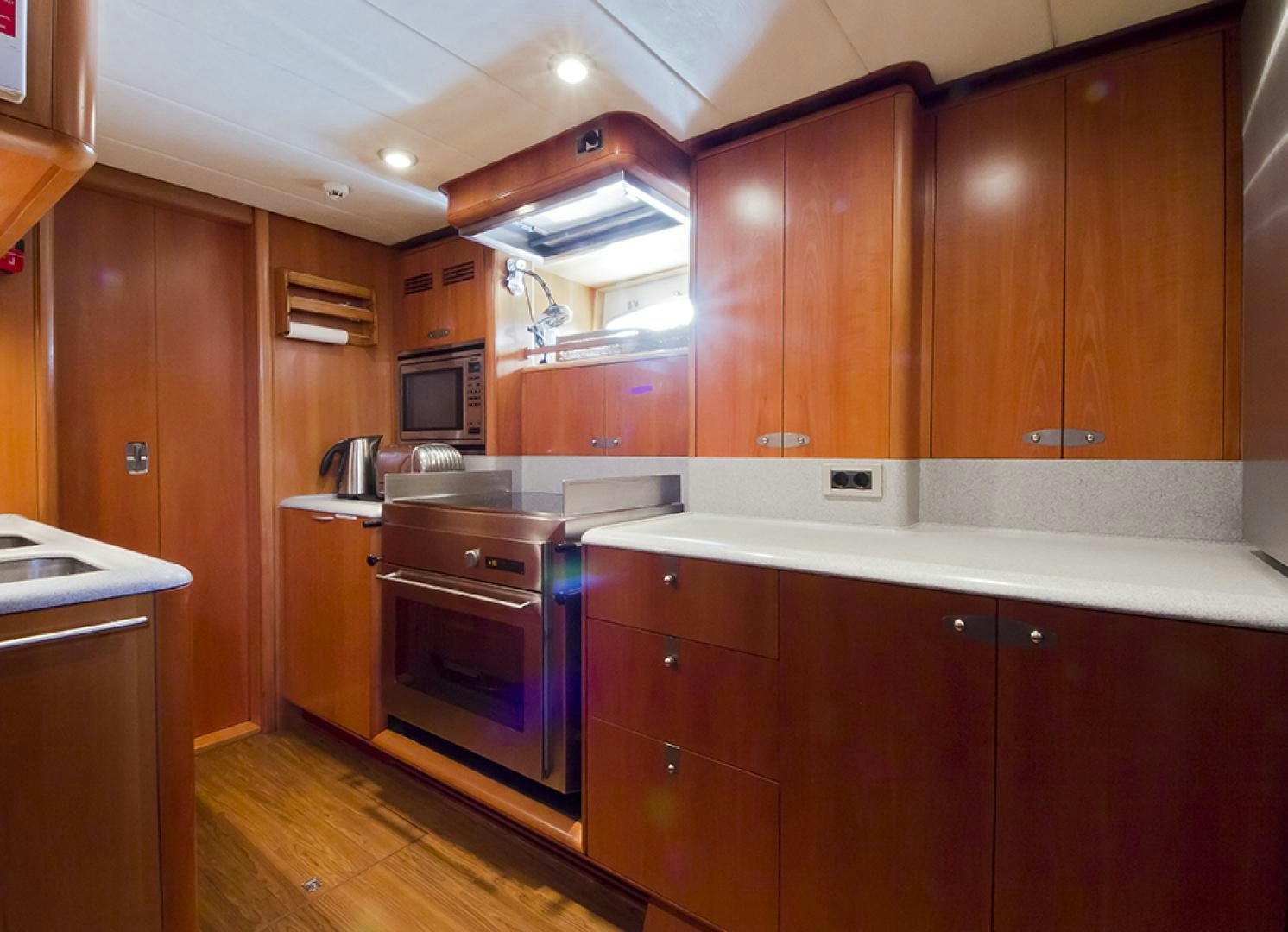 a kitchen with wooden cabinets aboard HAVANA OF LONDON Yacht for Sale