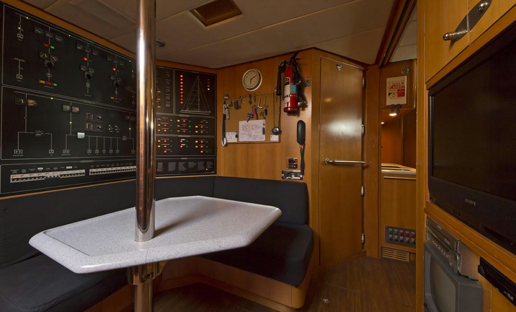 a room with a couch and a tv aboard HAVANA OF LONDON Yacht for Sale