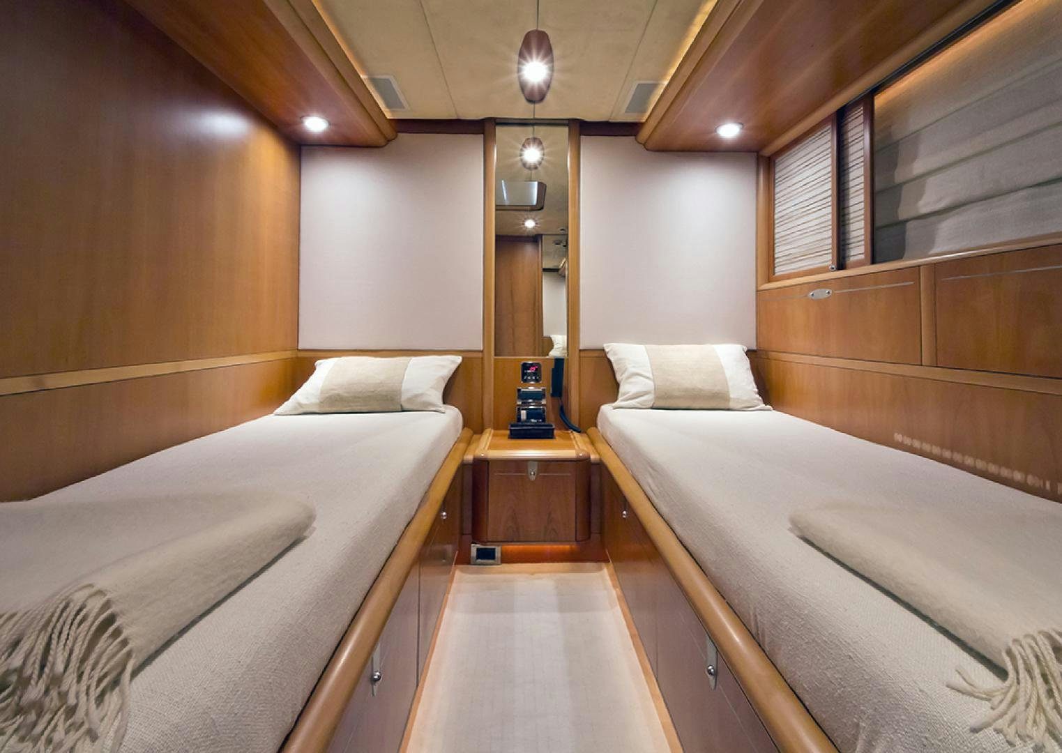 a room with beds and a table aboard HAVANA OF LONDON Yacht for Sale