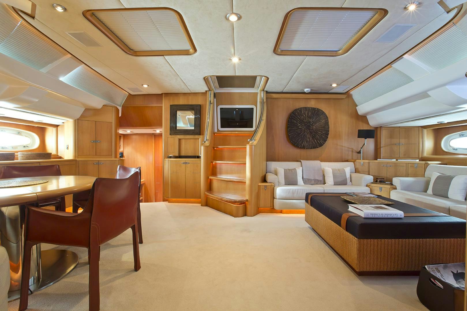 a living room with a bed and a couch aboard HAVANA OF LONDON Yacht for Sale