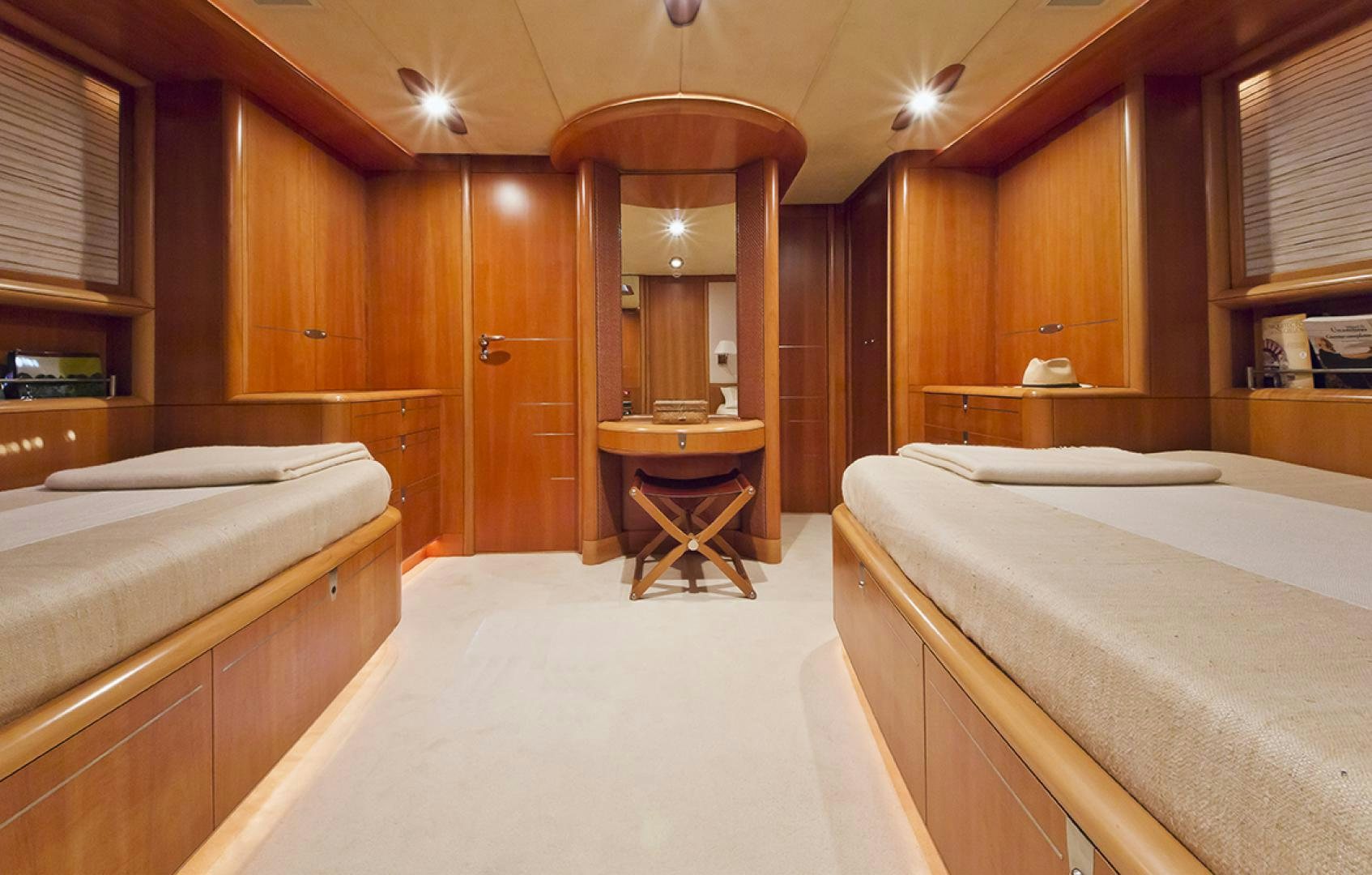 a room with a bed and a table aboard HAVANA OF LONDON Yacht for Sale