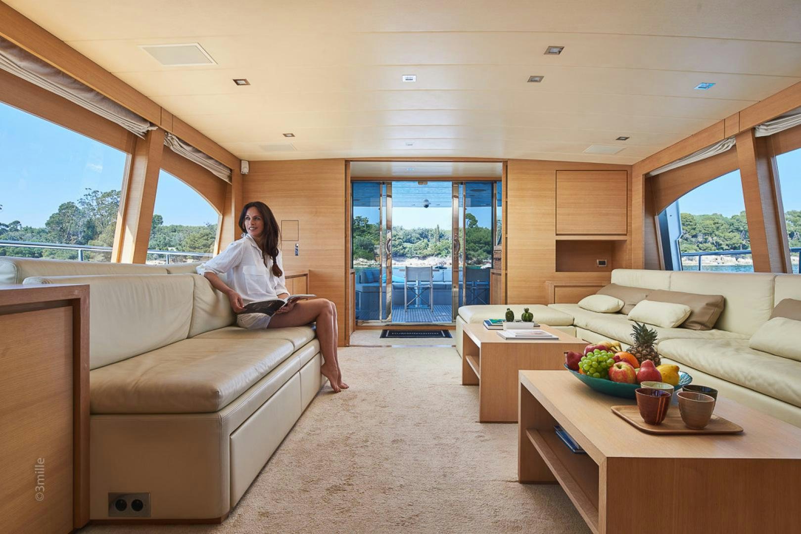 a person sitting on a couch in a living room aboard HUMMINGBIRD Yacht for Sale