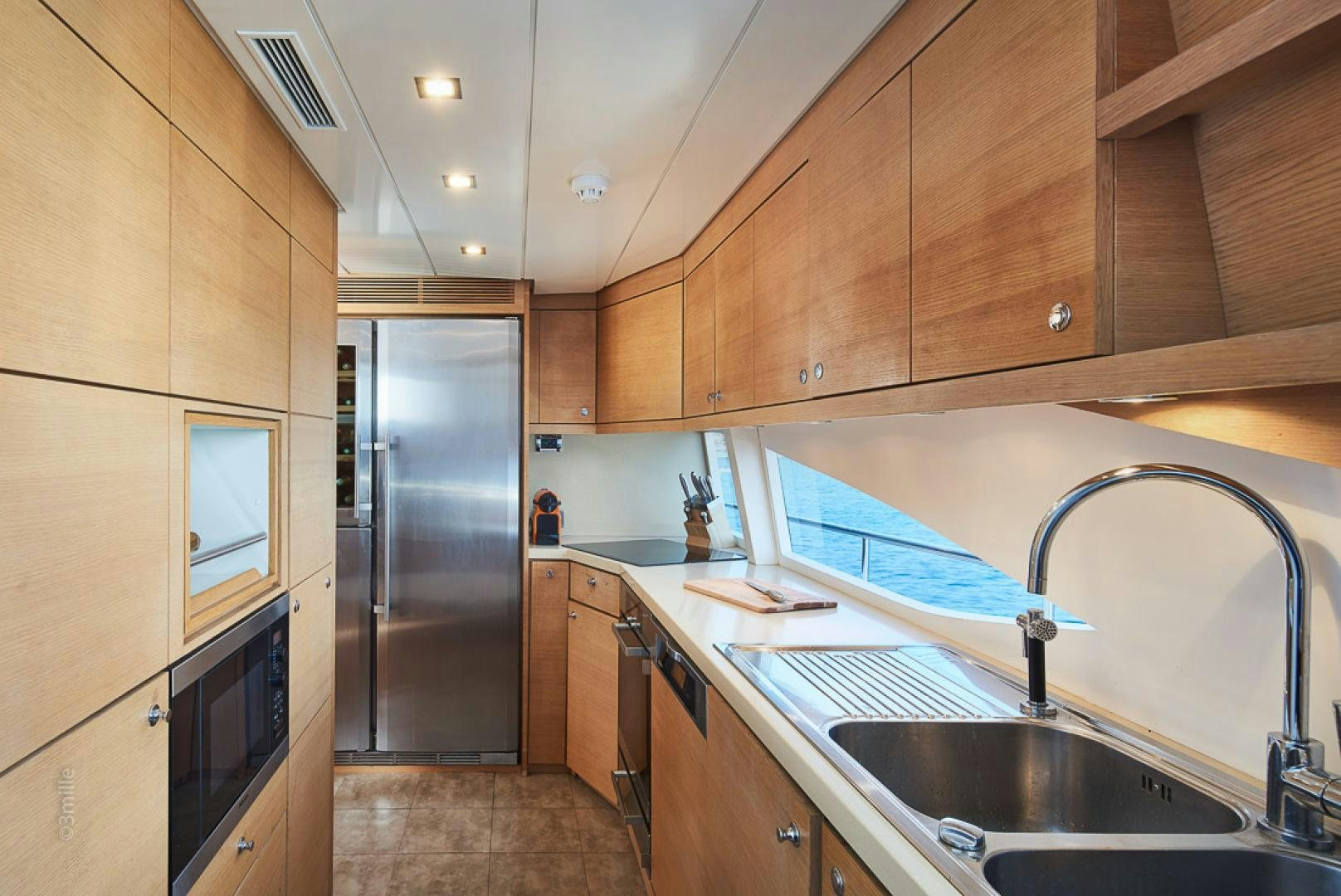a kitchen with wooden cabinets aboard HUMMINGBIRD Yacht for Sale