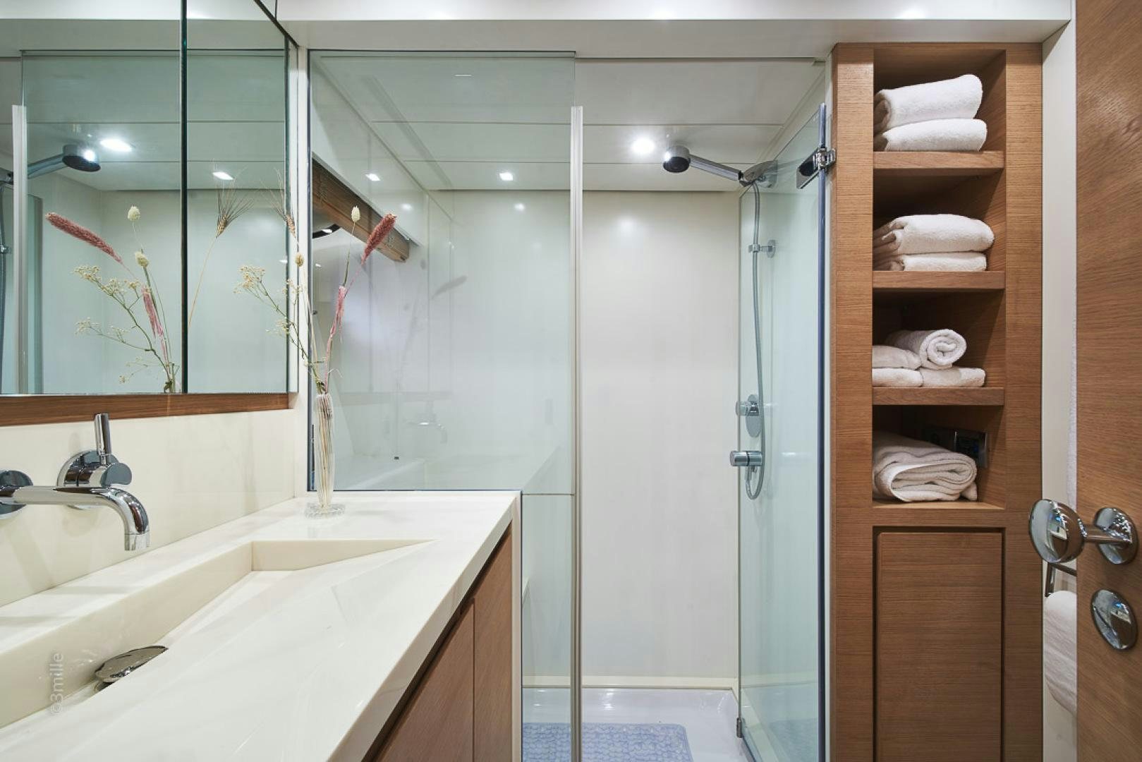 a bathroom with a glass shower aboard HUMMINGBIRD Yacht for Sale