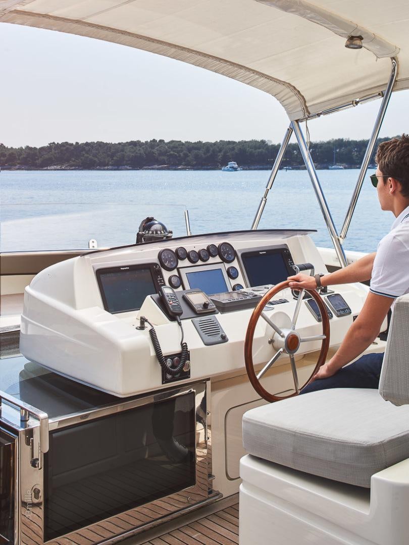 a person driving a boat aboard HUMMINGBIRD Yacht for Sale