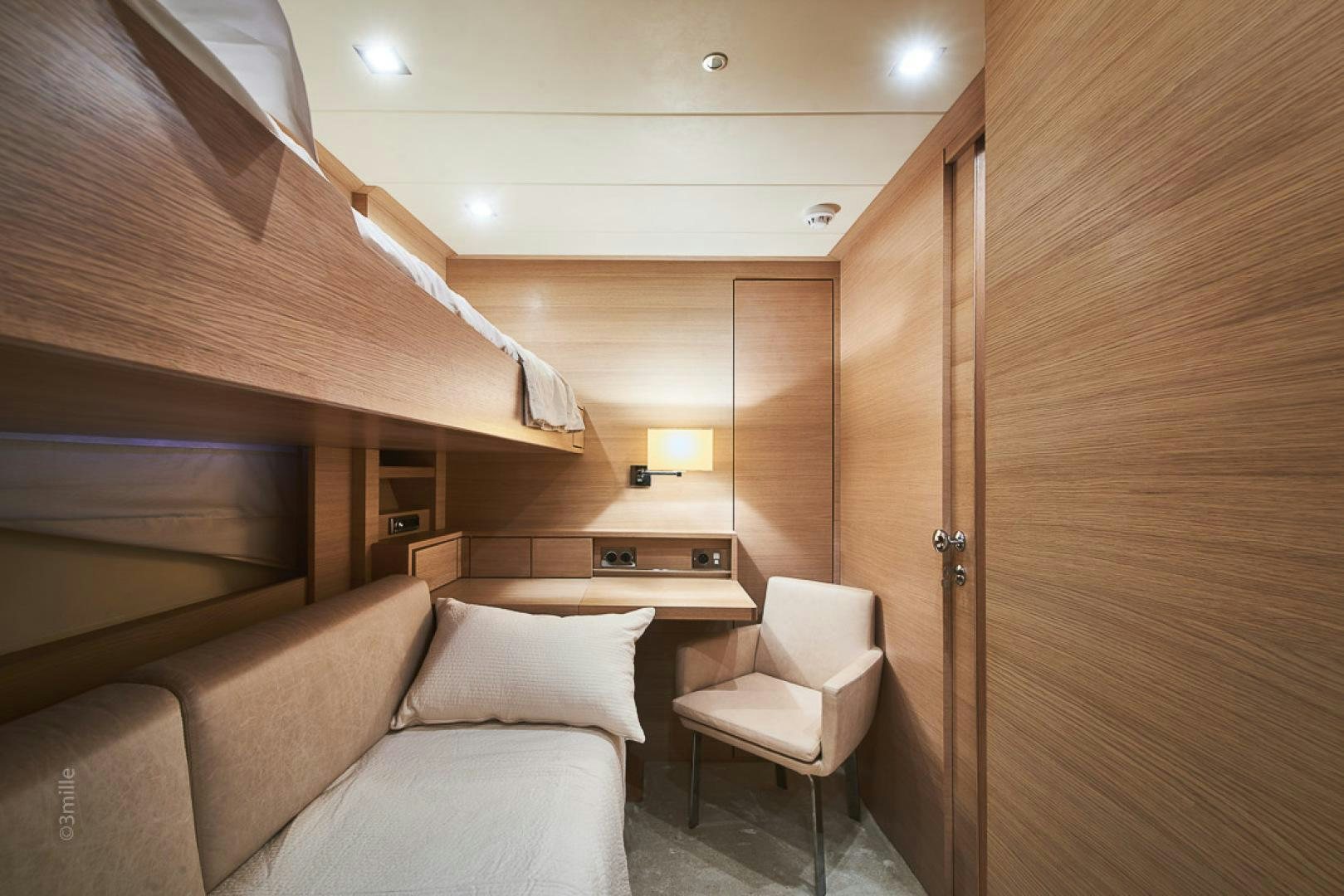 a room with a couch and a wood door aboard HUMMINGBIRD Yacht for Sale