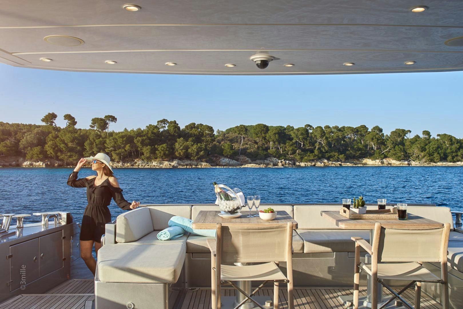 a person standing on a deck overlooking a body of water aboard HUMMINGBIRD Yacht for Sale