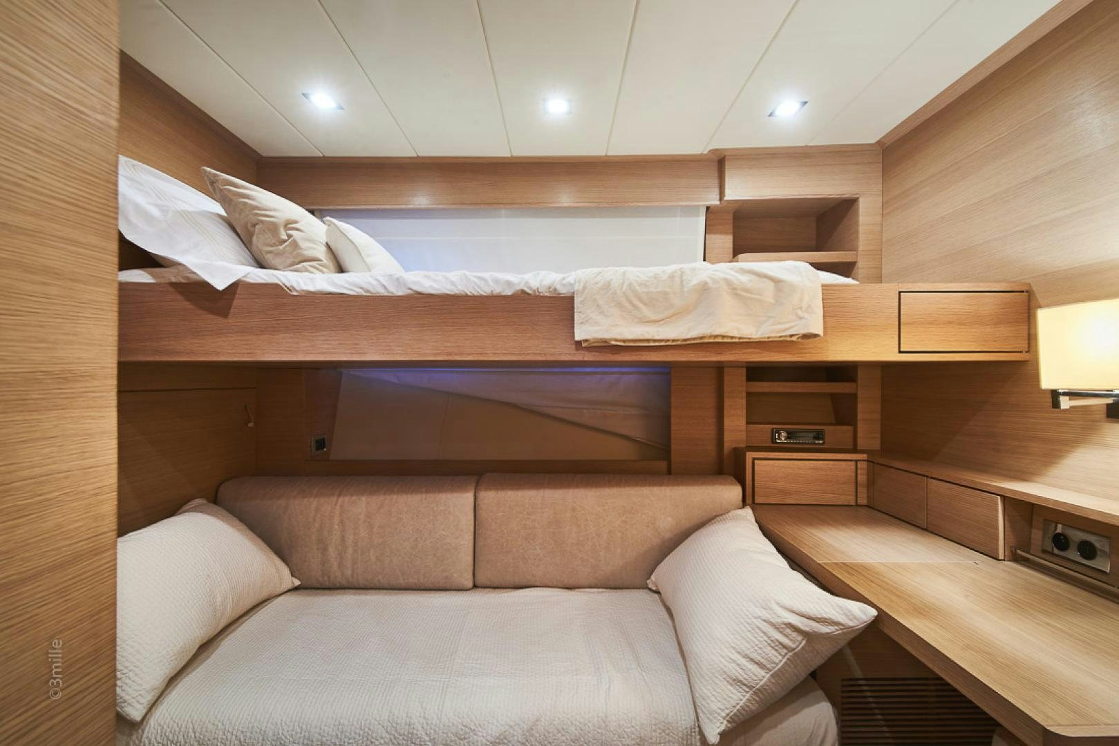 a bed with a couch aboard HUMMINGBIRD Yacht for Sale