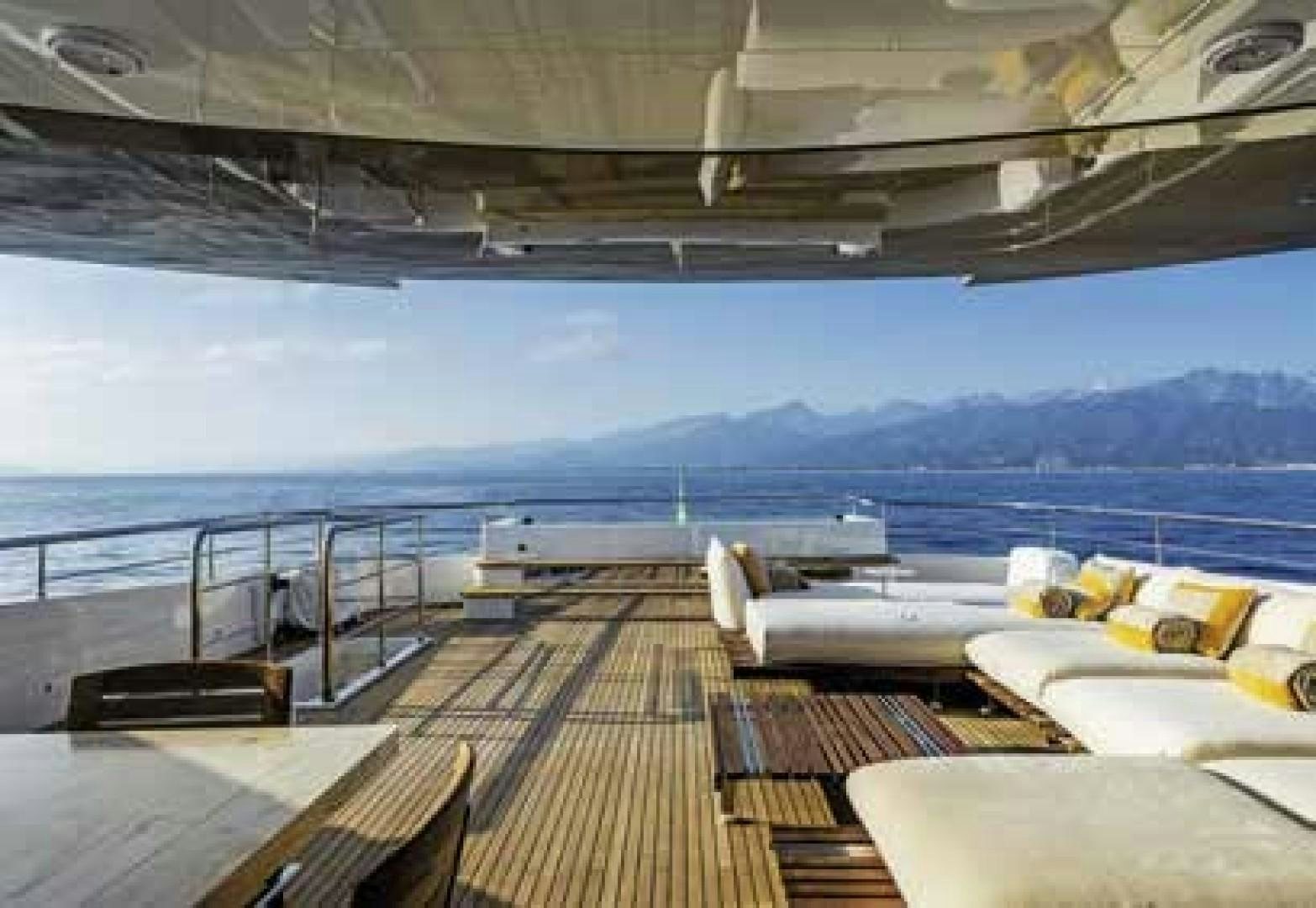 a deck with a view of the ocean and mountains aboard No Name Yacht for Sale