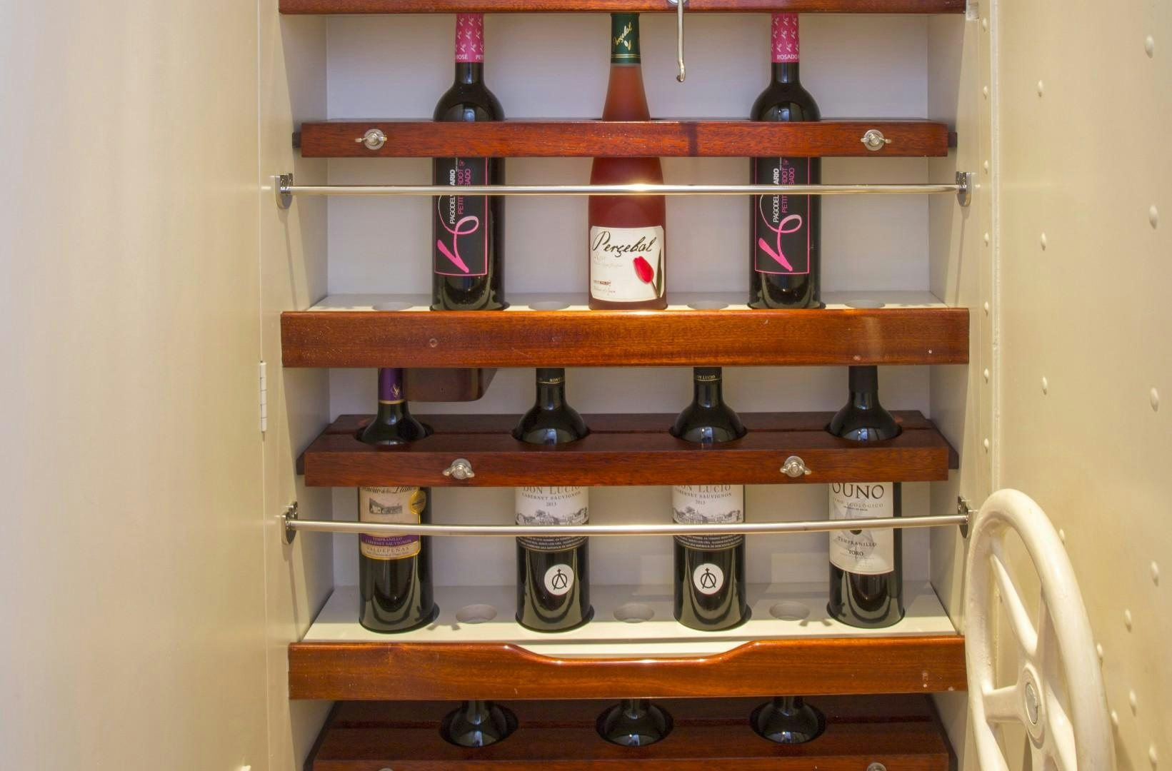 a shelf with a variety of bottles on it aboard JUPITER Yacht for Sale