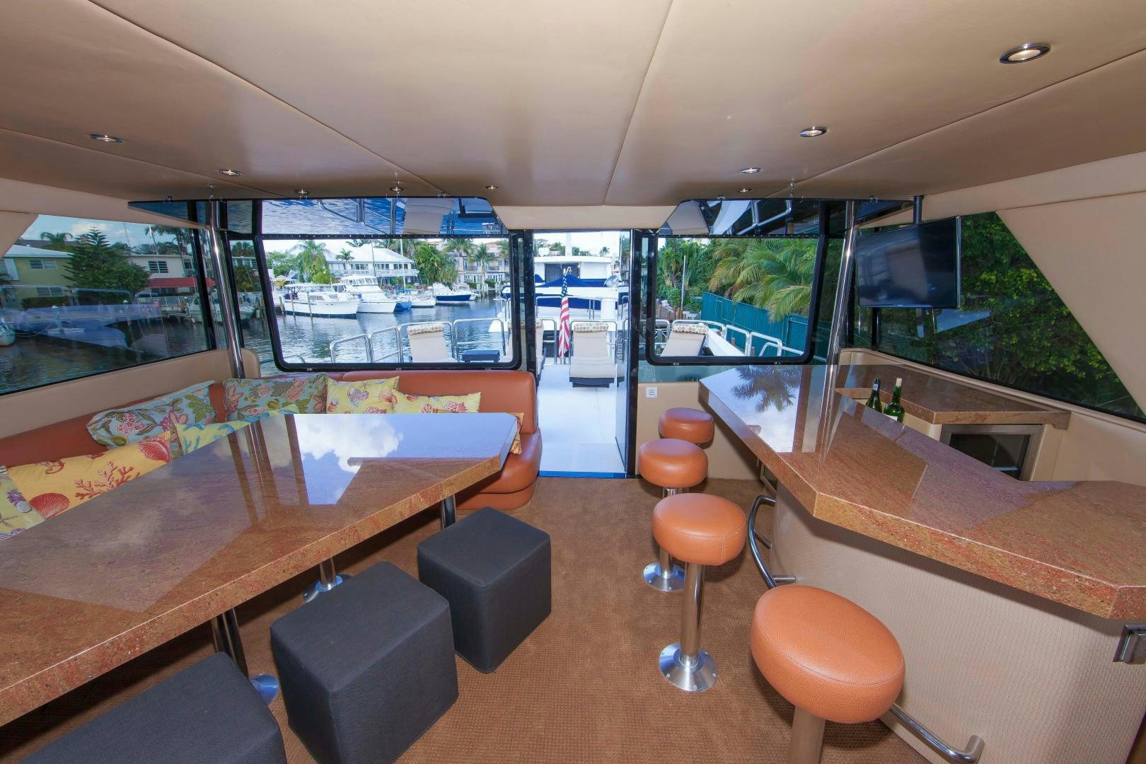 a room with a table chairs and a window aboard MONARCH Yacht for Sale