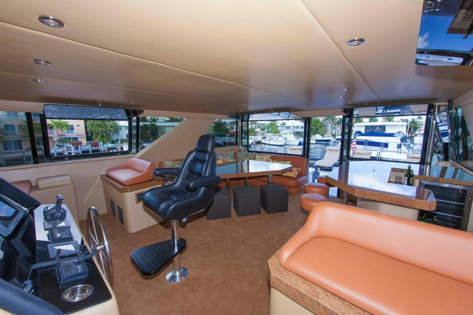 a room with a large window and a table with chairs and a large window aboard MONARCH Yacht for Sale