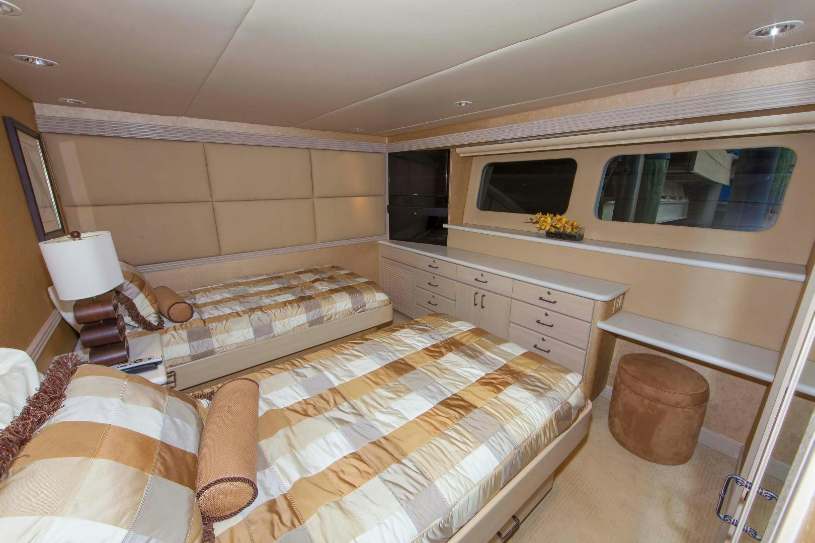 a bedroom with a bed and a dresser aboard MONARCH Yacht for Sale