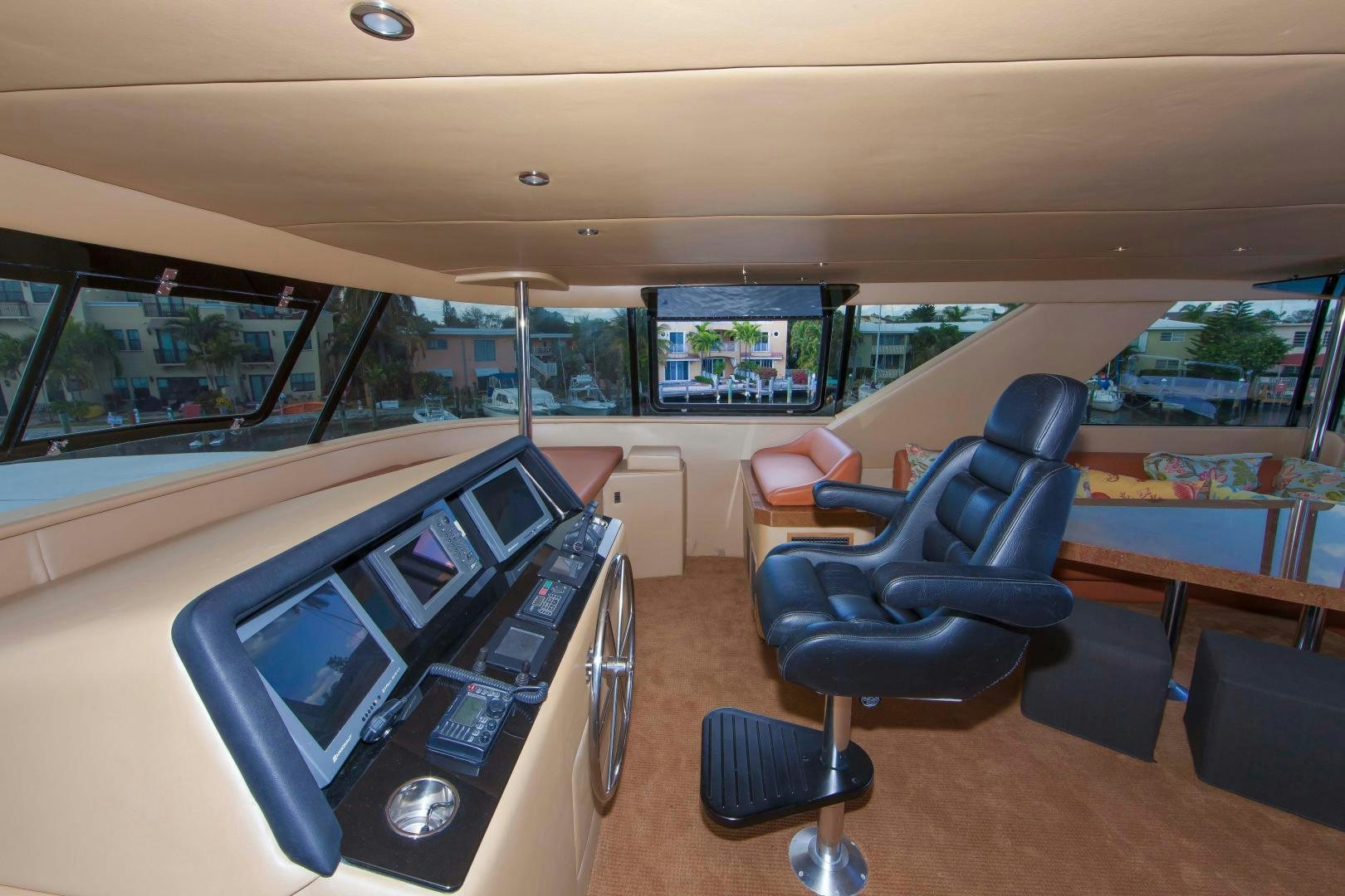 a room with a large window and a desk with a computer on it aboard MONARCH Yacht for Sale