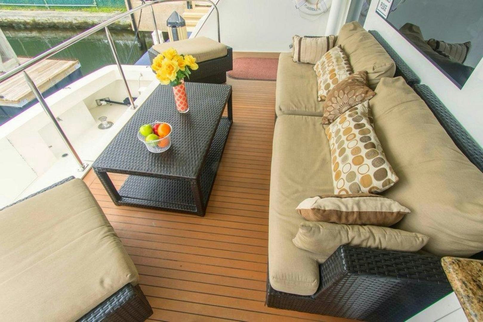 a living room with a couch and a table aboard MONARCH Yacht for Sale