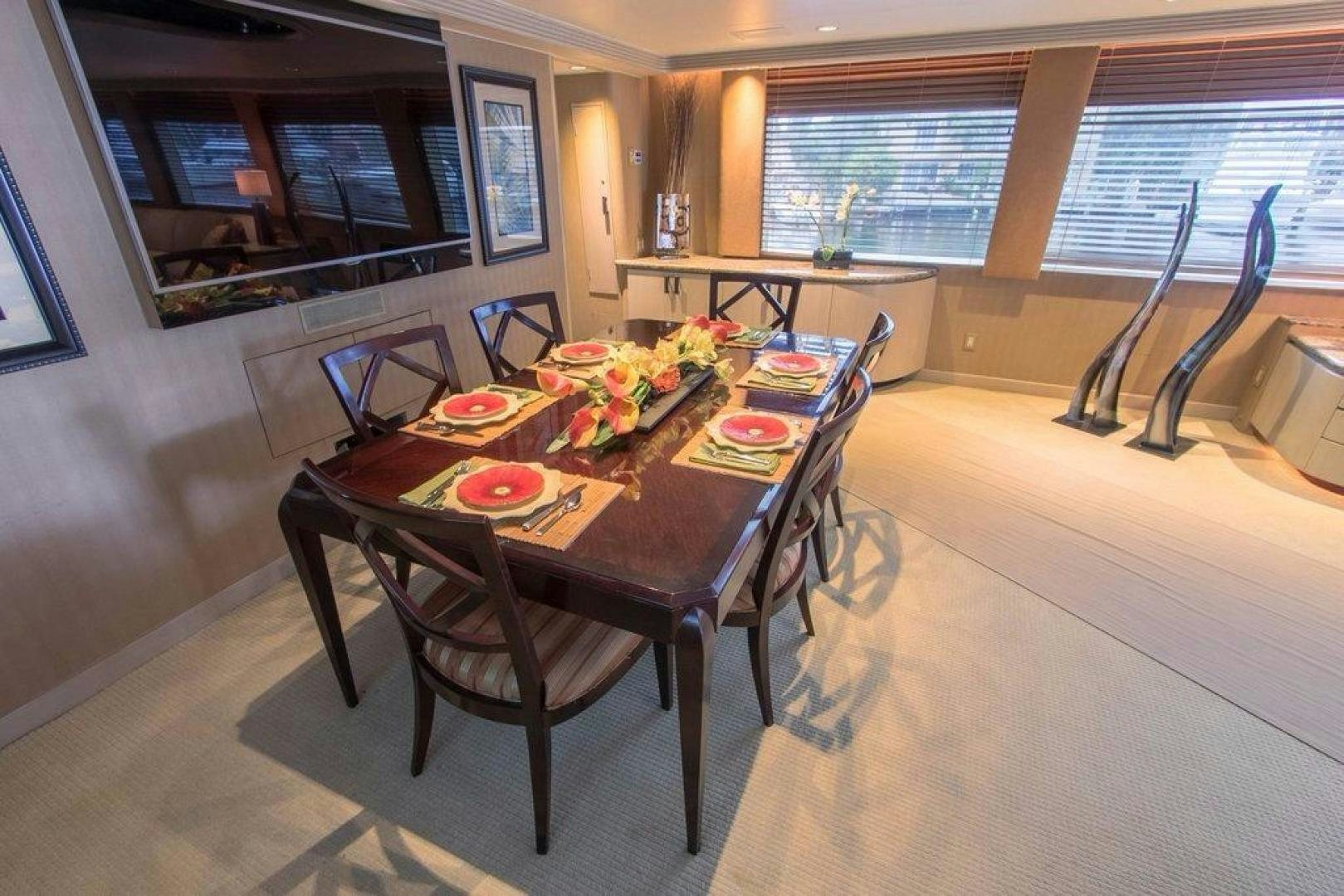 a dining table in a room aboard MONARCH Yacht for Sale