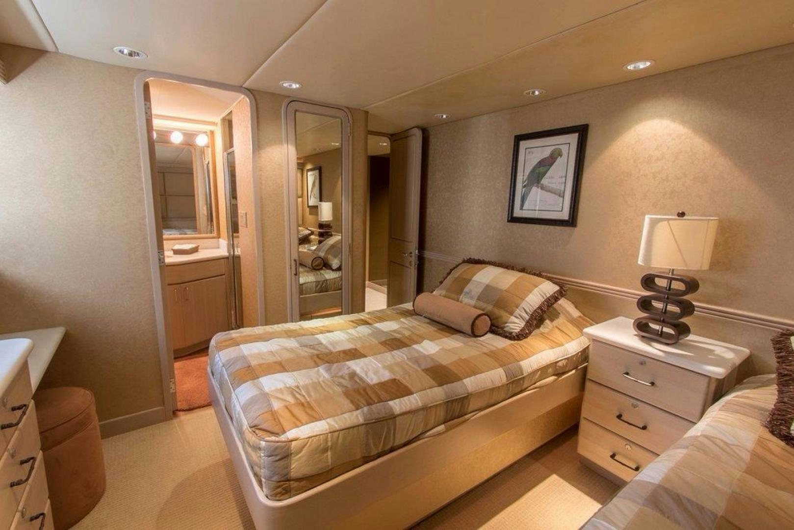 a bedroom with a bed and a mirror aboard MONARCH Yacht for Sale