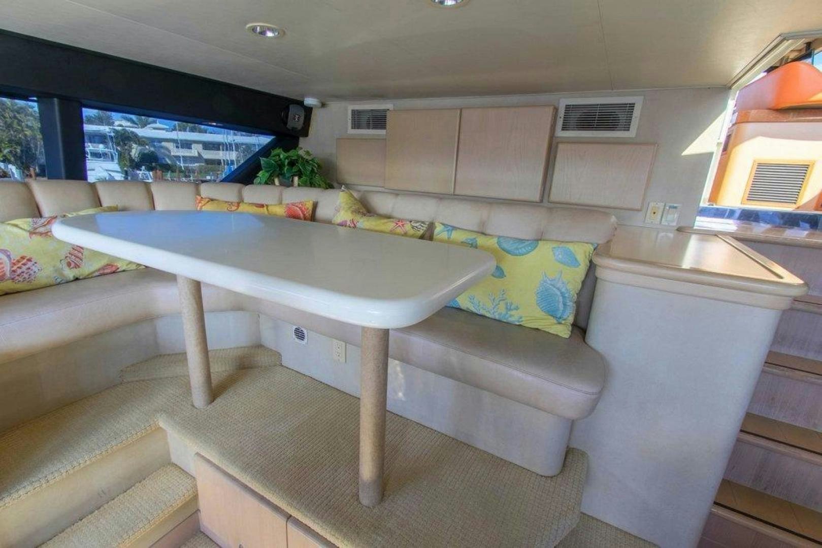 a living room with a table and couches aboard MONARCH Yacht for Sale