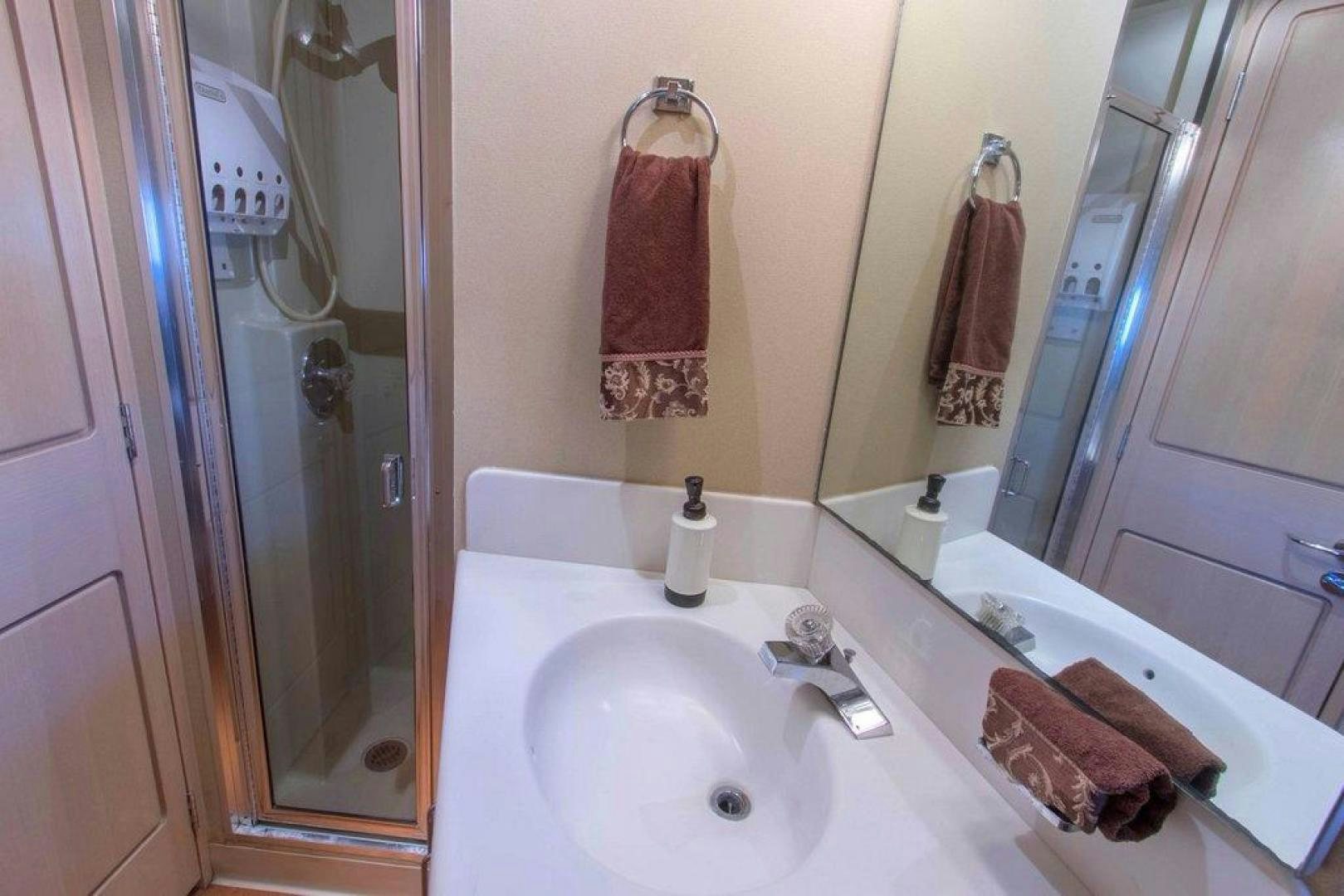 a bathroom with a sink and towels aboard MONARCH Yacht for Sale