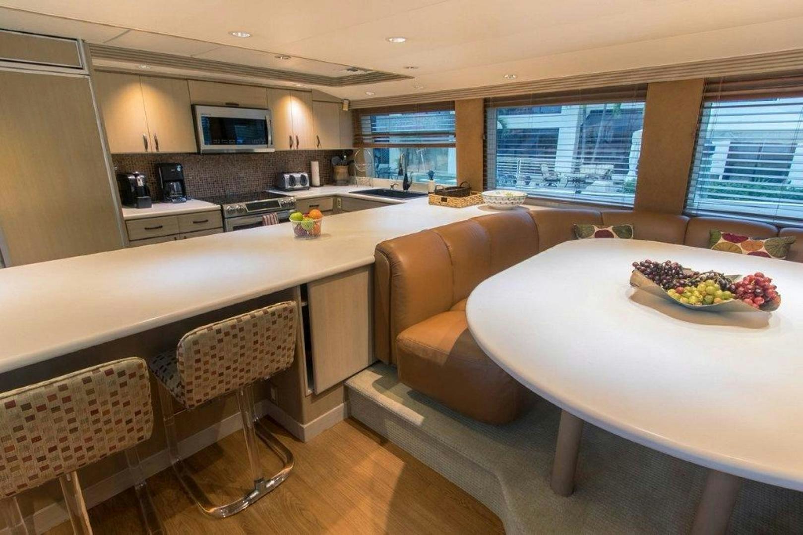 a kitchen with a table and chairs aboard MONARCH Yacht for Sale