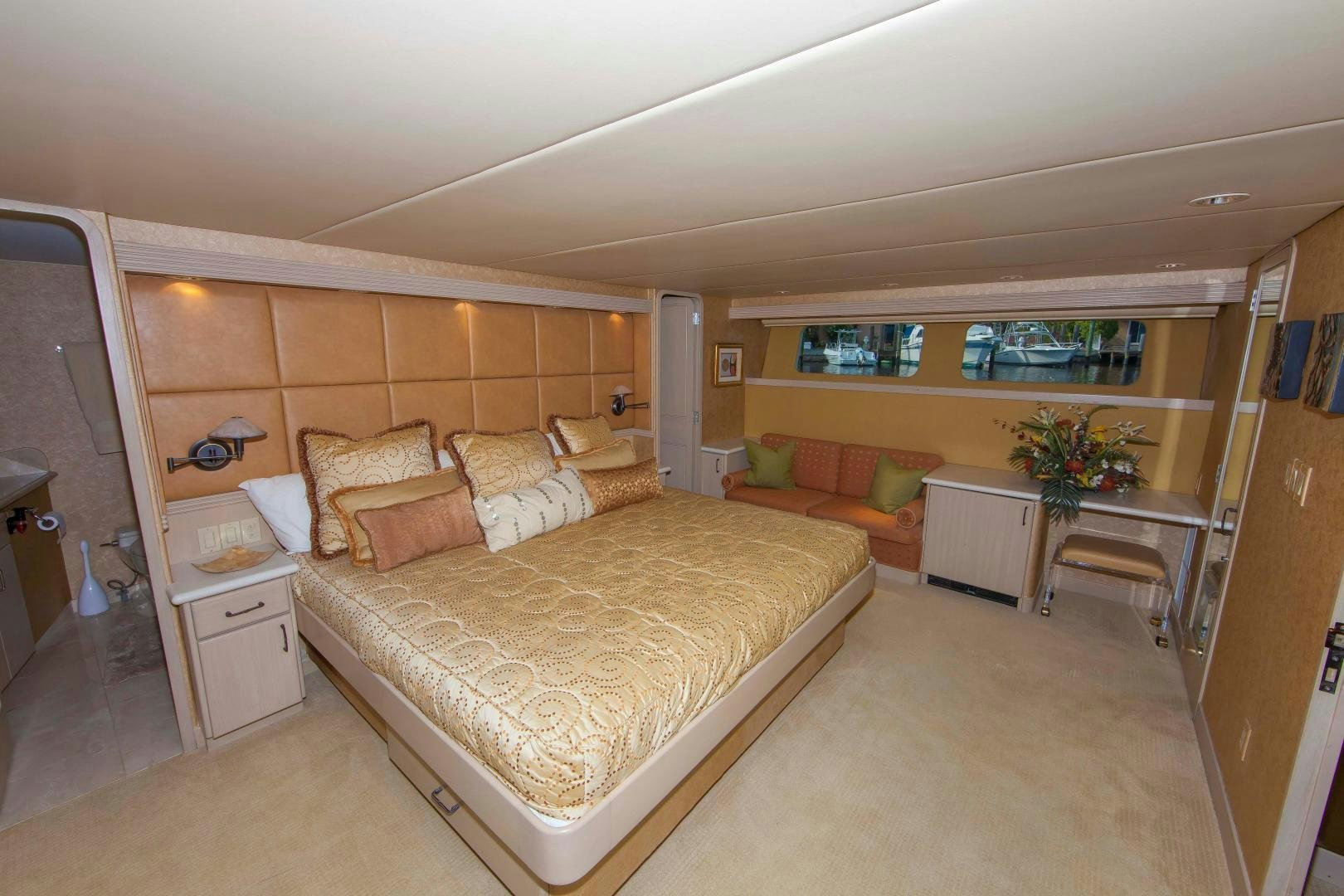 a bedroom with a bed and a desk aboard MONARCH Yacht for Sale