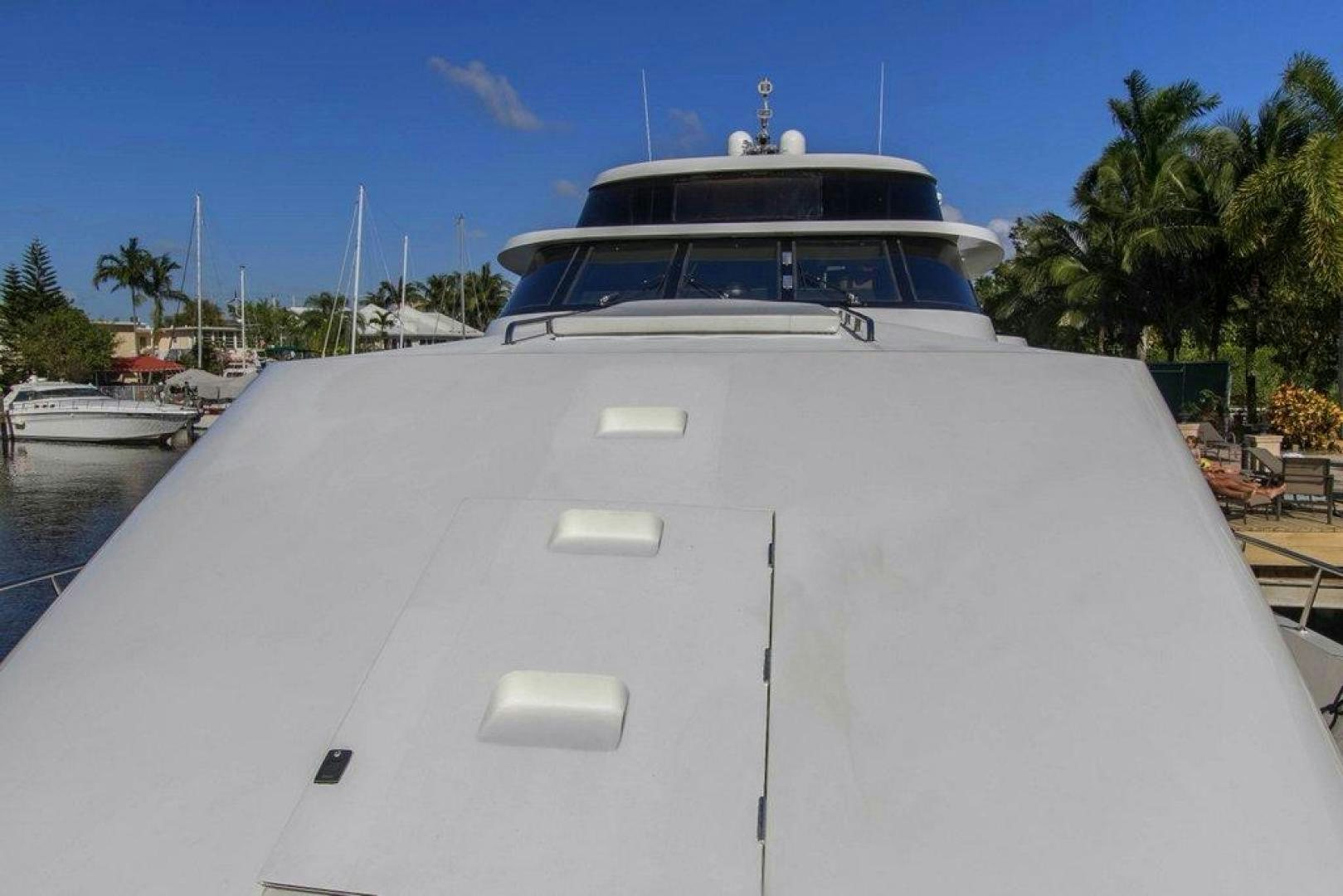 a white yacht in a harbor aboard MONARCH Yacht for Sale