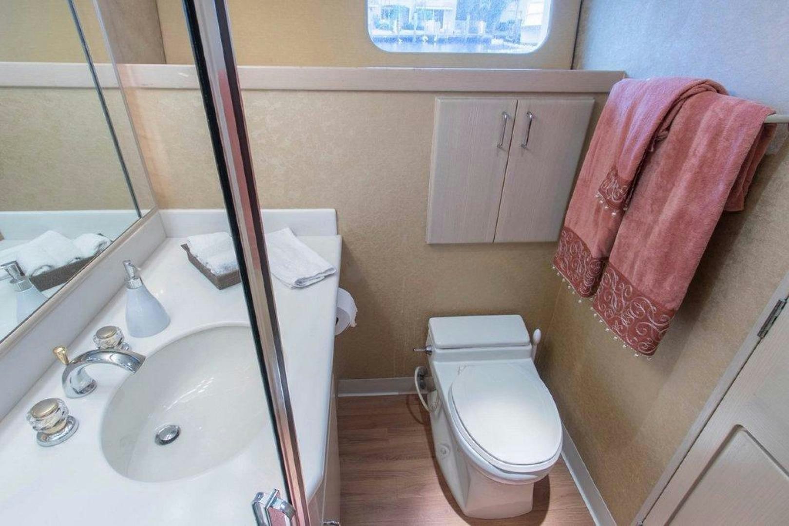 a bathroom with a sink toilet and a pink towel aboard MONARCH Yacht for Sale