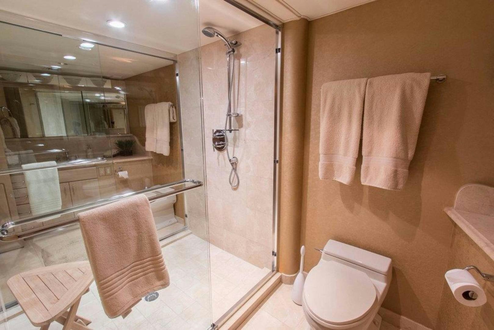 a bathroom with a shower and toilet aboard MONARCH Yacht for Sale