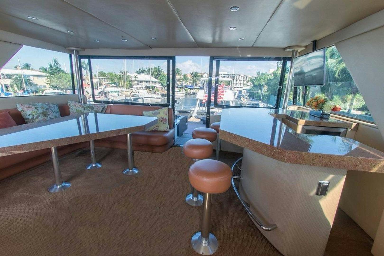 a room with tables and chairs aboard MONARCH Yacht for Sale