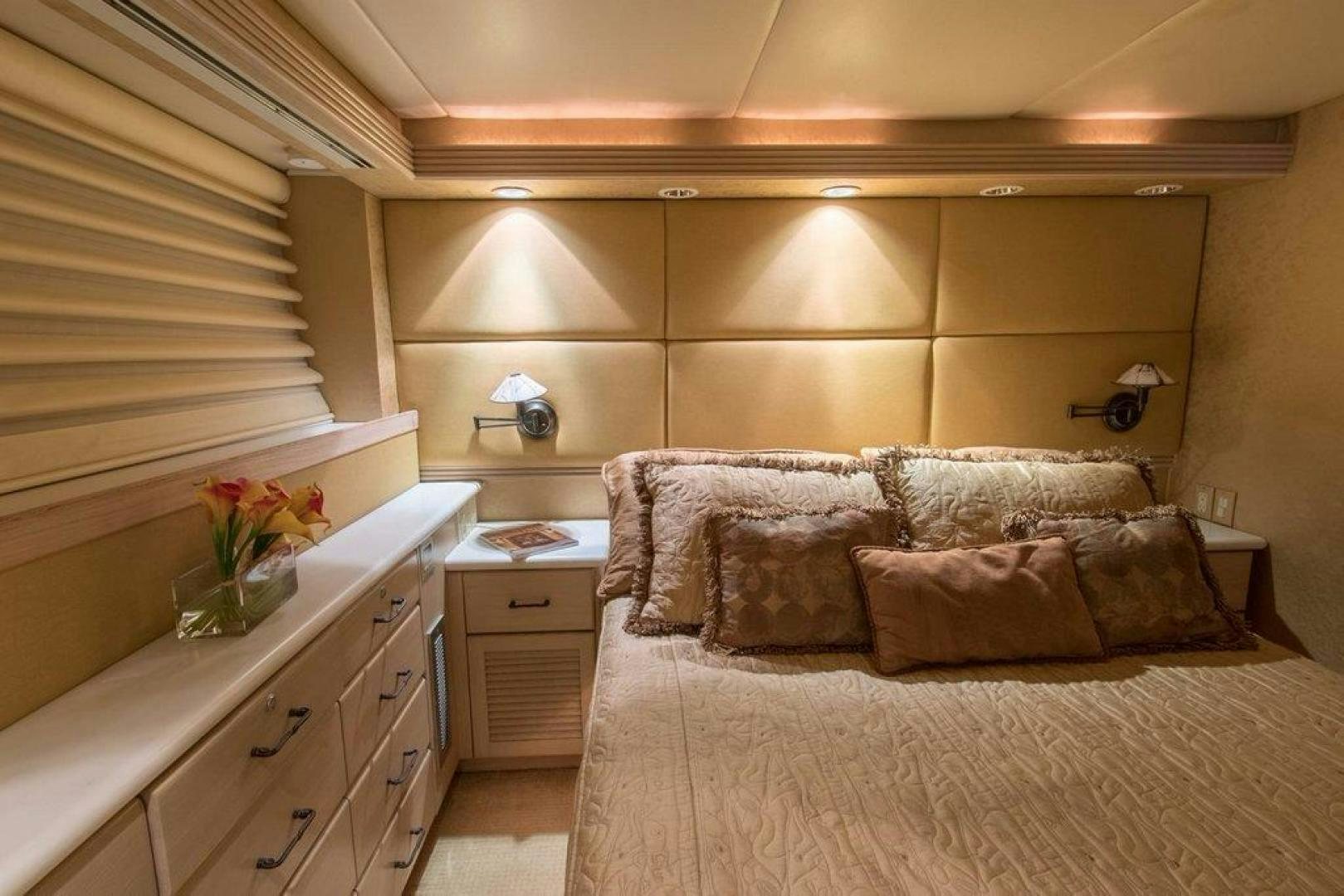 a bedroom with a bed and a dresser aboard MONARCH Yacht for Sale
