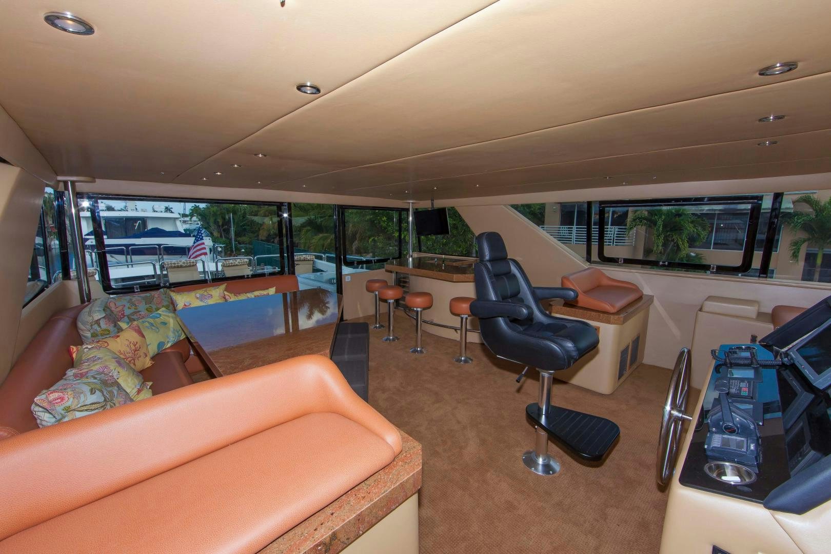 a living room with a large window aboard MONARCH Yacht for Sale