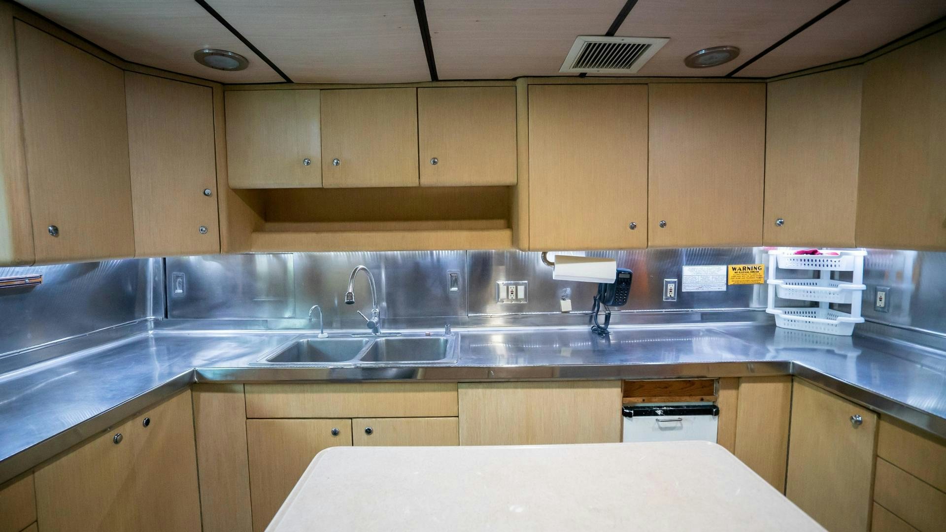 a kitchen with wooden cabinets aboard MARAZUL Yacht for Sale