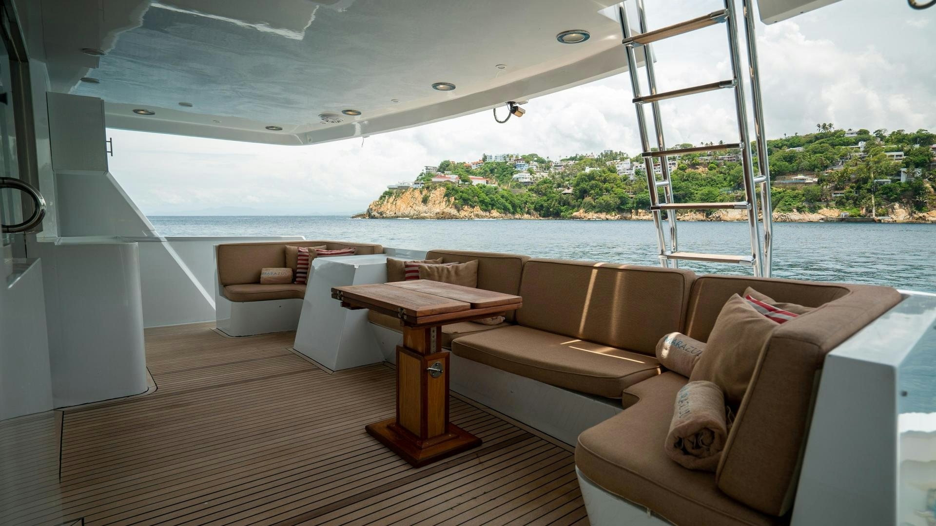 a room with couches and a table aboard MARAZUL Yacht for Sale