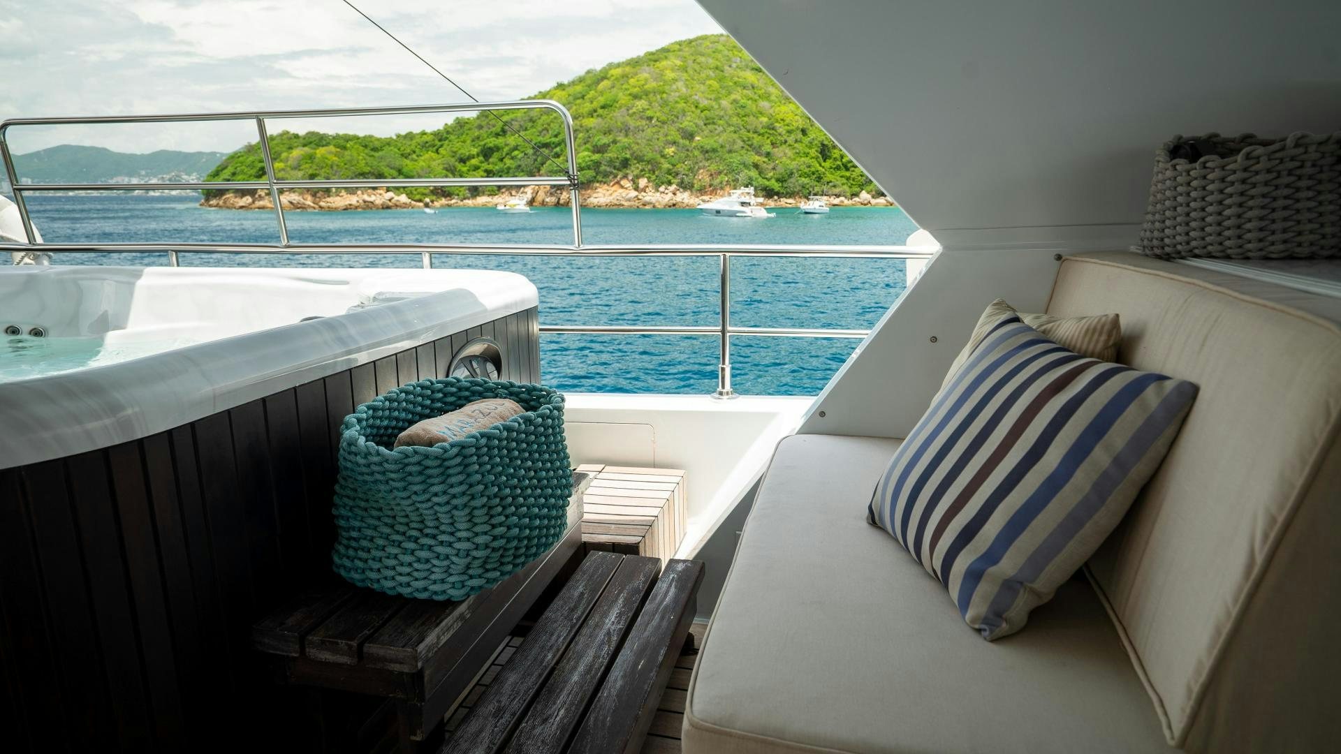 a room with a bed and a chair and a large body of water aboard MARAZUL Yacht for Sale