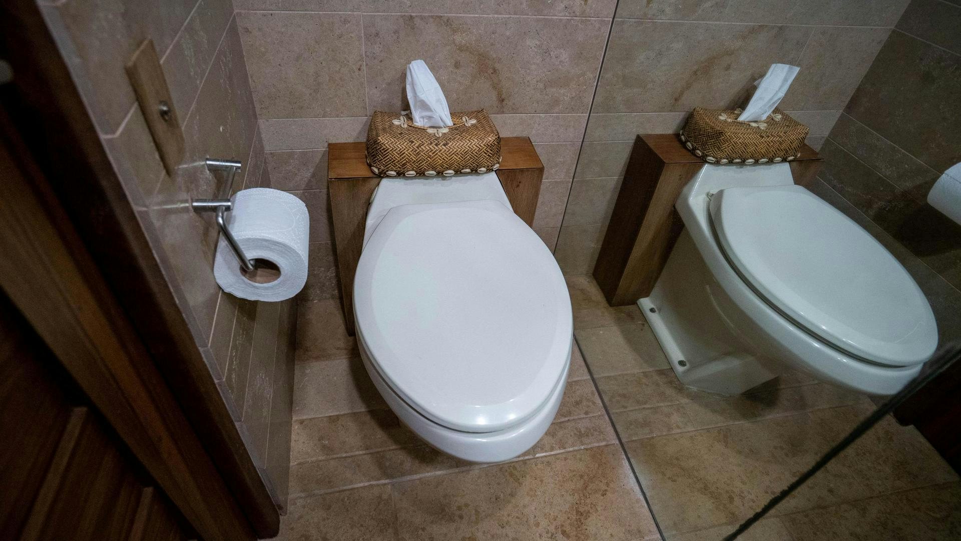 a toilet with a wooden seat aboard MARAZUL Yacht for Sale