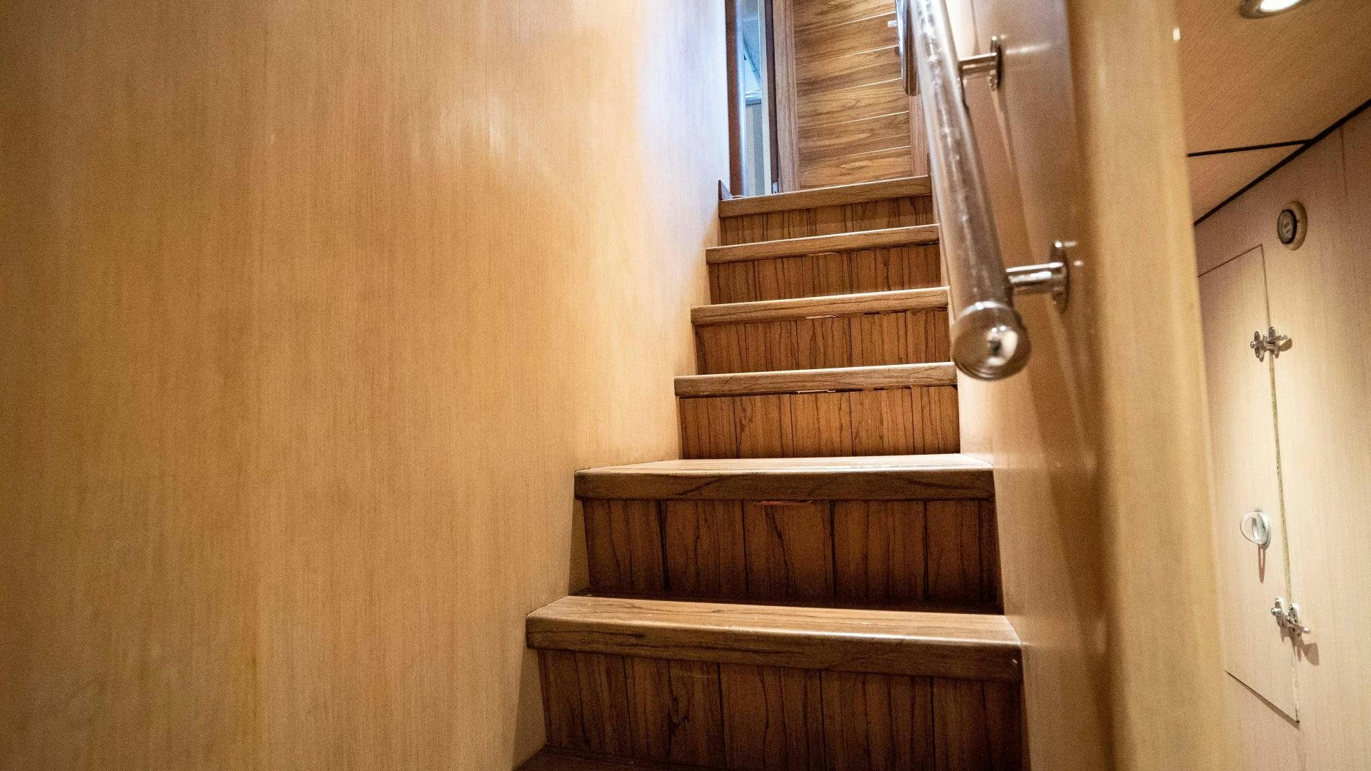 a wooden staircase with a door aboard MARAZUL Yacht for Sale