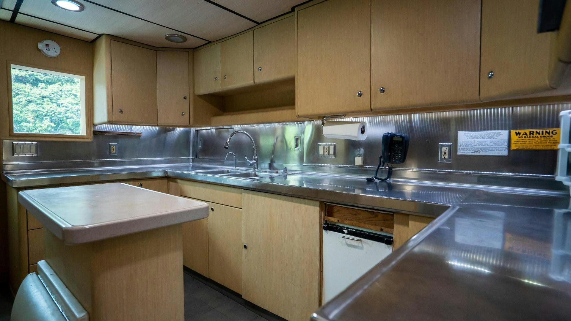 a kitchen with wooden cabinets aboard MARAZUL Yacht for Sale