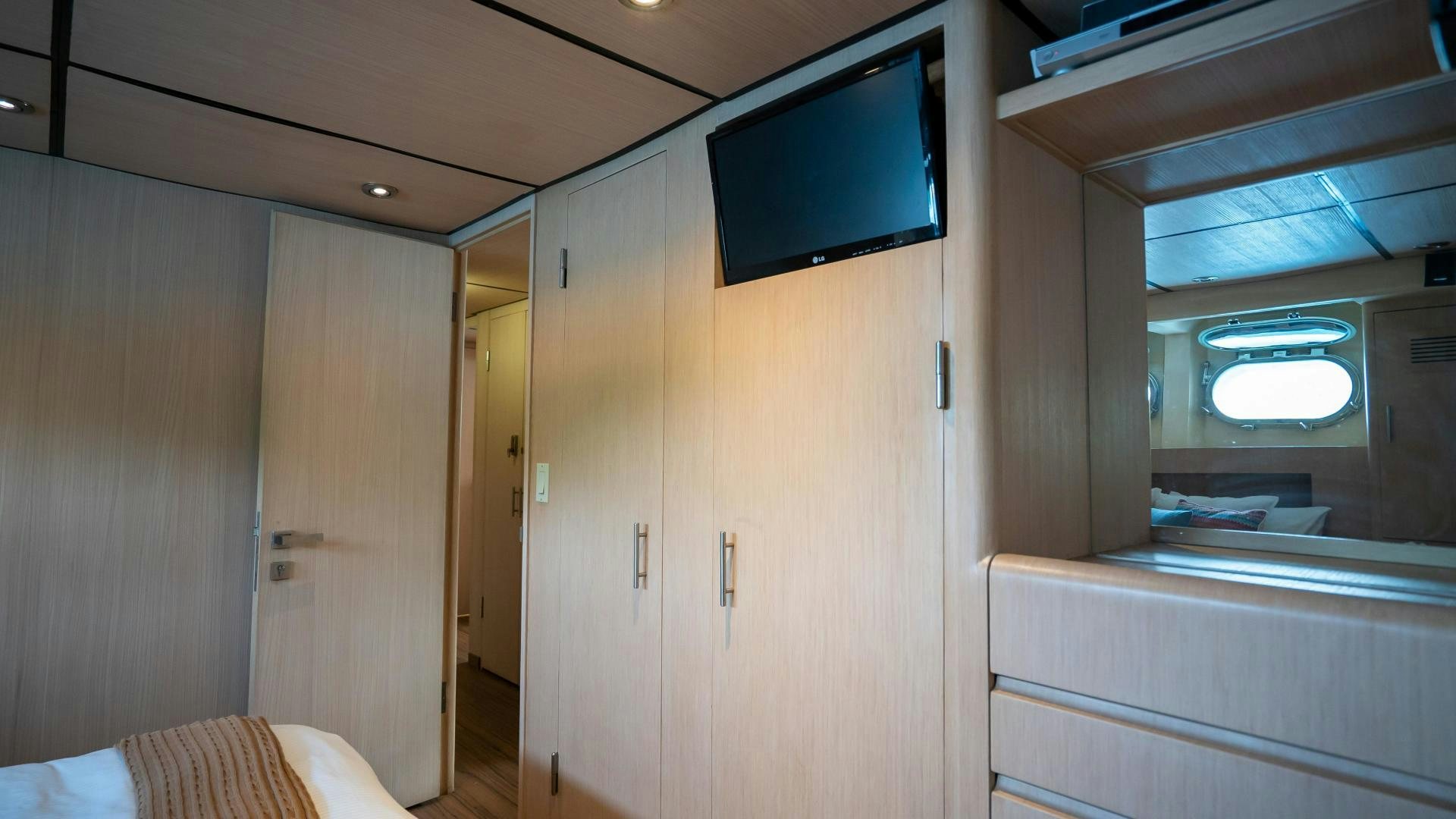 a room with a bed and a television aboard MARAZUL Yacht for Sale