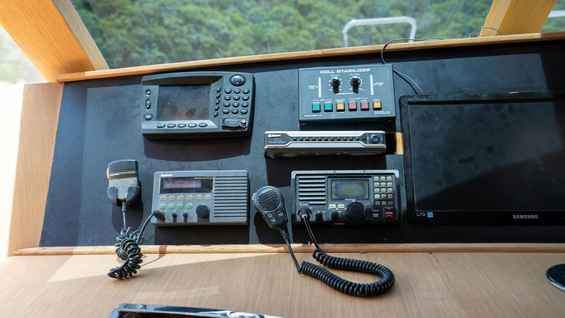 a black electronic device with a glass and a wine glass aboard MARAZUL Yacht for Sale