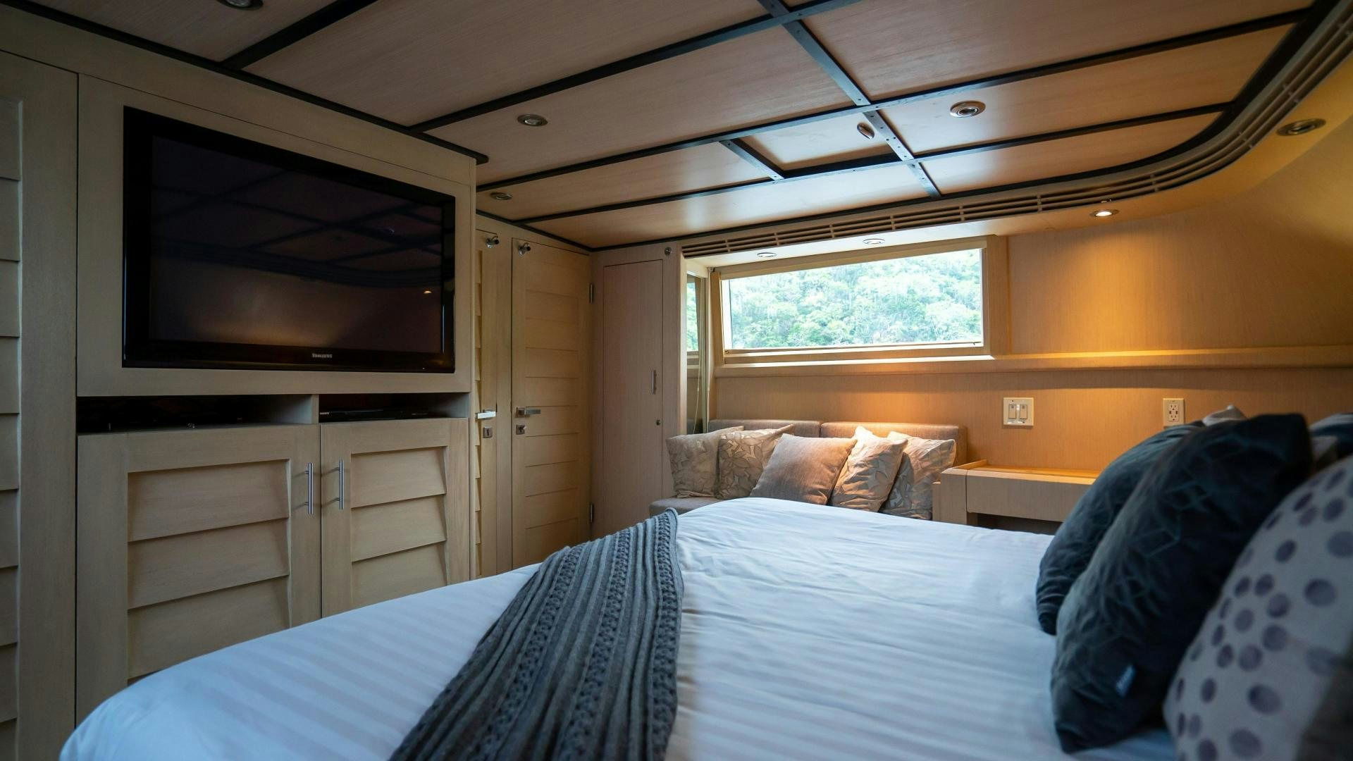 a bedroom with a bed and a television aboard MARAZUL Yacht for Sale