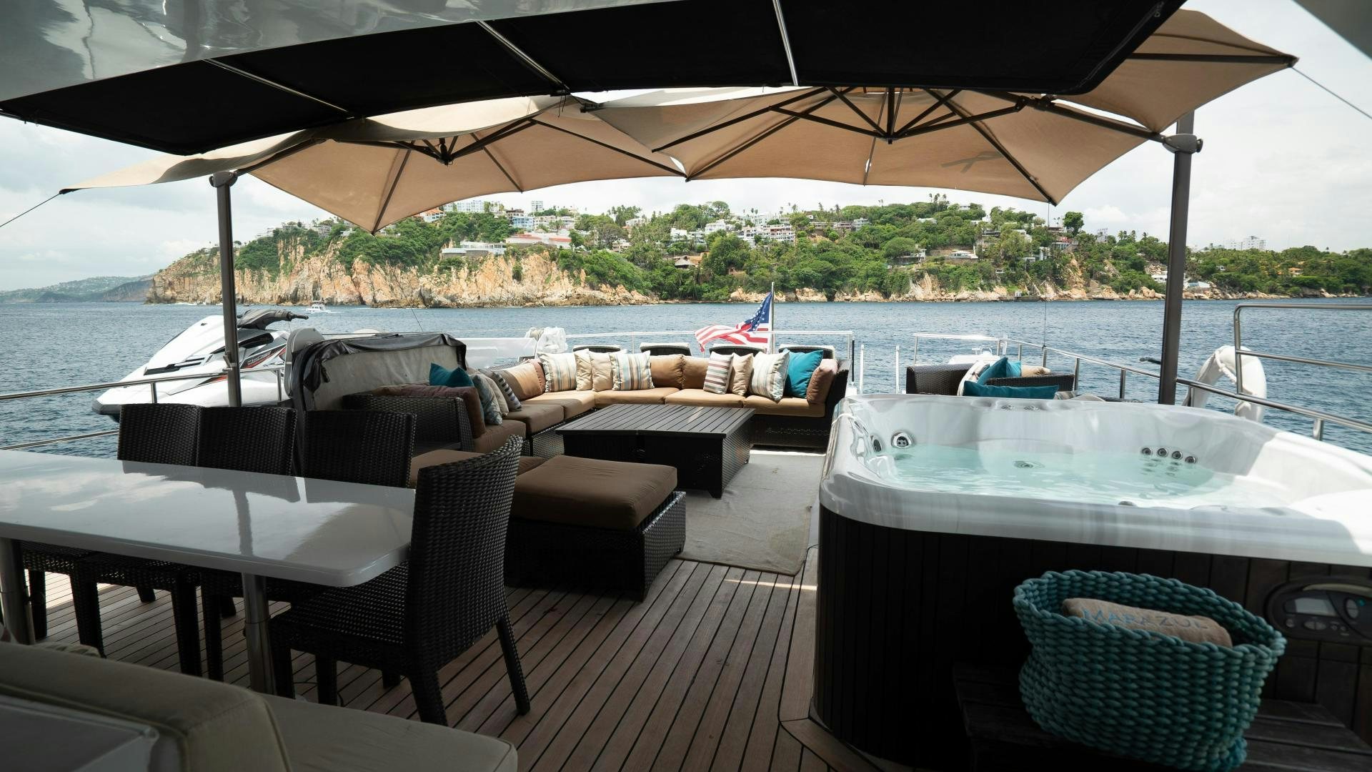 a deck with a table and chairs on it aboard MARAZUL Yacht for Sale