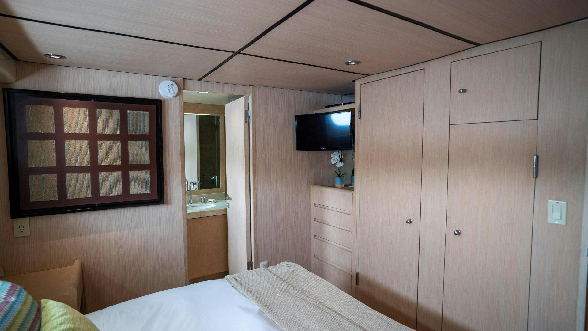 a room with a bed and a television aboard MARAZUL Yacht for Sale
