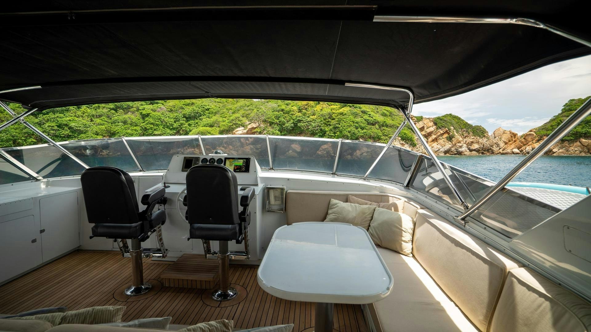 a car with a chair and a table and chairs on a deck aboard MARAZUL Yacht for Sale